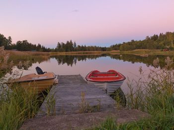 Boat moored in lake against sky