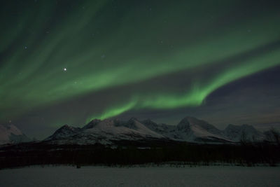 Scenic view of aurora borealis over lyngen alps