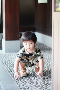 Portrait of cute girl sitting on floor