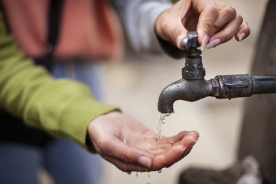 Close-up of hand holding faucet