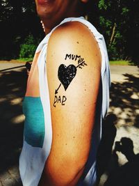 Close-up of man holding heart shape with text