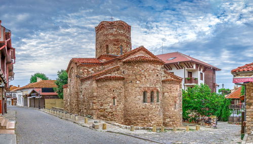 Old buildings against sky in city