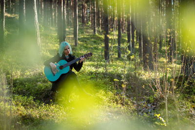 Man playing guitar on field