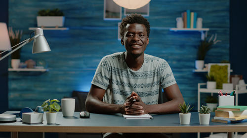 Portrait of smiling businessman sitting at office