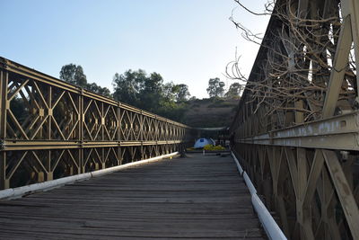 View of footbridge against clear sky