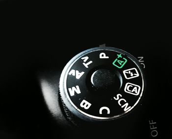 Close-up of camera against black background