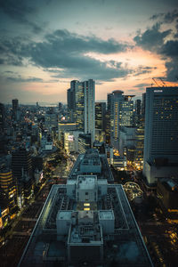 High angle view of illuminated cityscape against sky at night