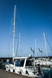 Sail boats moored in harbor