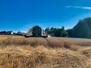 View of agricultural field against clear blue sky