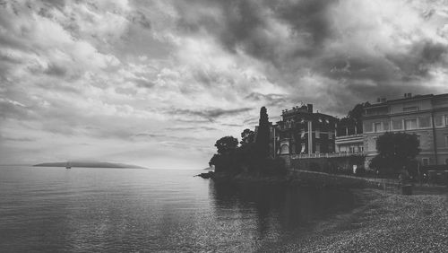 Panoramic view of sea and buildings against sky