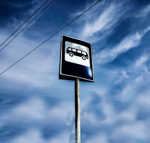 Low angle view of road sign against sky