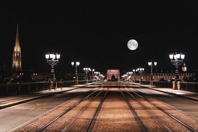 View of illuminated railroad tracks at night