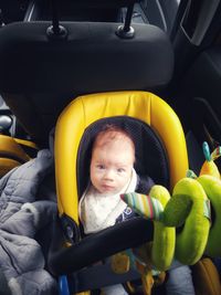 Portrait of cute girl in car