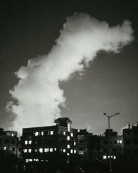Low angle view of buildings against sky at night