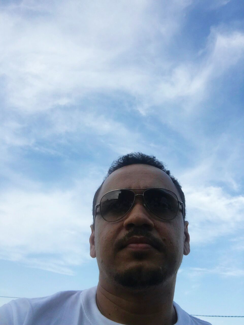 sky, portrait, one person, headshot, cloud - sky, front view, men, sunglasses, glasses, males, low angle view, mid adult men, day, lifestyles, leisure activity, nature, real people, mid adult, mature men, fashion, outdoors, human face