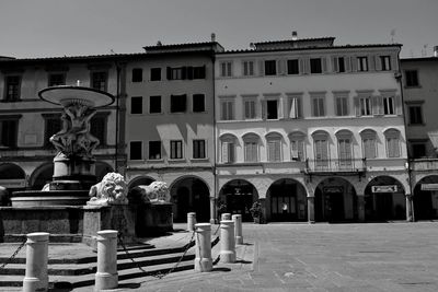 Statue on table in front of building