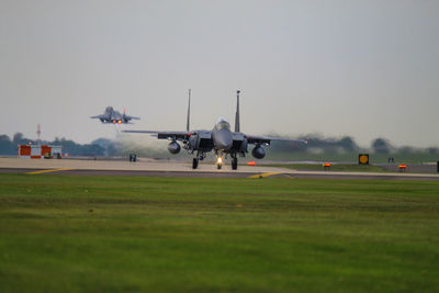 Two f-15s one taking off the other taxing 