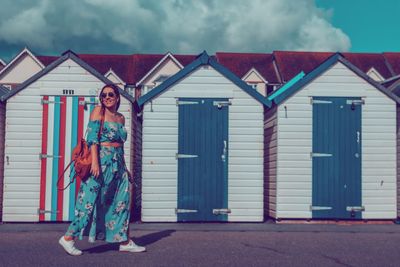 Portrait of woman standing against building