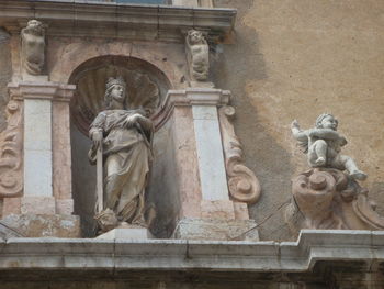 Low angle view of statue against building