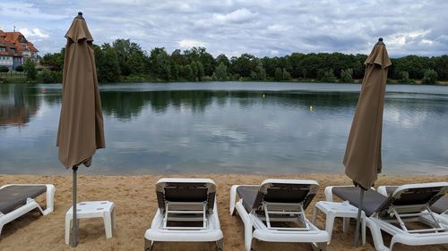 Scenic view of lake by trees against sky