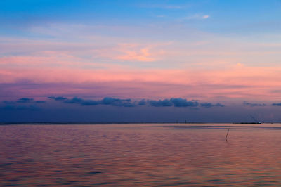 Scenic view of sea against sky at sunset