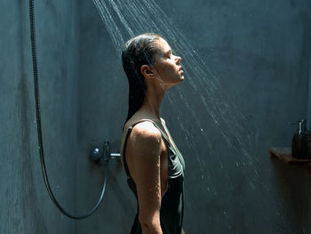 Rear view of woman standing in water