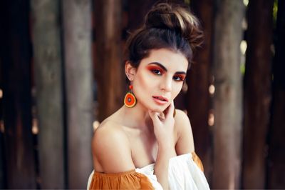 Portrait of beautiful young woman wearing make-up in forest