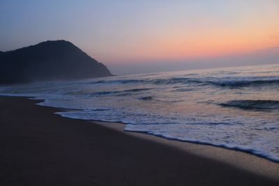 Scenic view of sea against clear sky during sunset