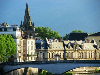 Canal in front of cathedral against blue sky