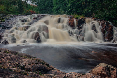 Scenic view of waterfall in forest