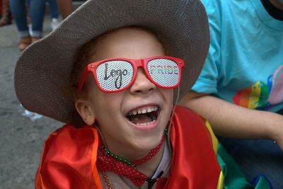 Close-up of boy wearing hat and sunglasses