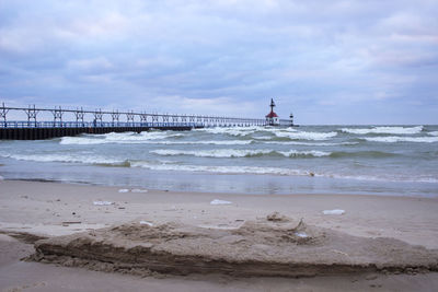 View of beach against cloudy sky