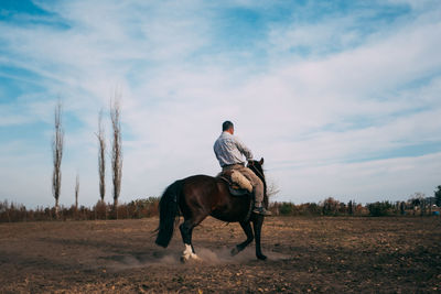 Portrait of man riding horse