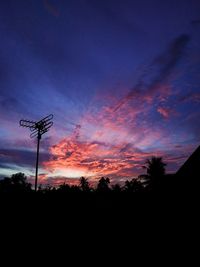 Low angle view of silhouette trees against sky at sunset