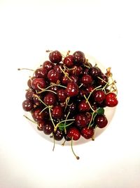 High angle view of cherries over white background