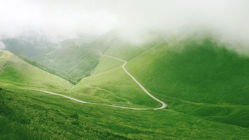 Scenic view of landscape against cloudy sky