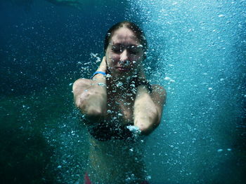 Portrait of young woman swimming in sea