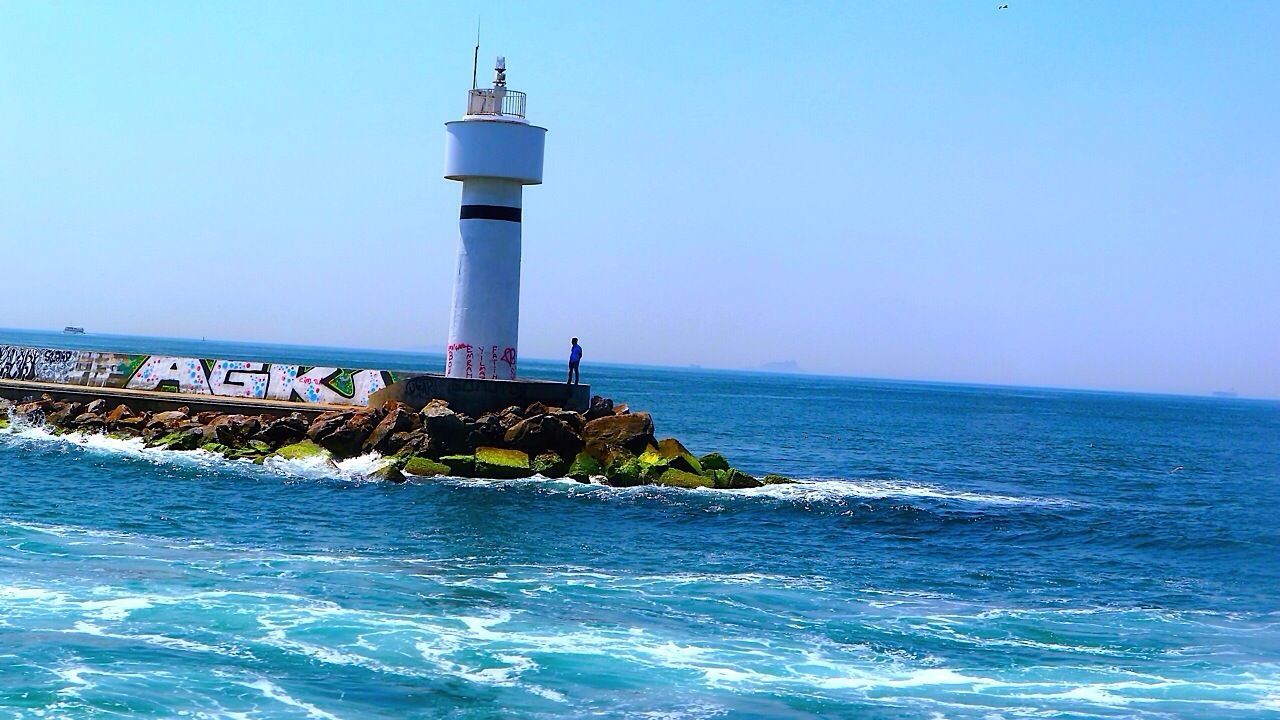sea, lighthouse, water, horizon over water, guidance, direction, protection, blue, built structure, clear sky, architecture, safety, building exterior, security, copy space, waterfront, tranquility, tranquil scene, tower, scenics