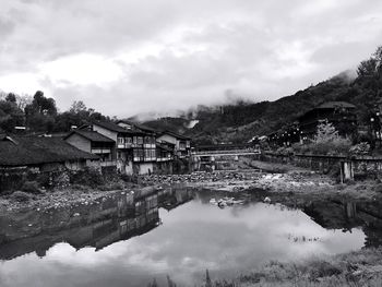 Reflection of houses and trees in water