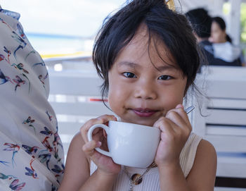 Close-up of girl holding coffee