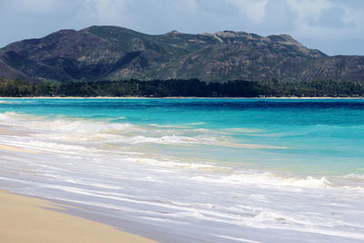 Scenic view of sea against mountains