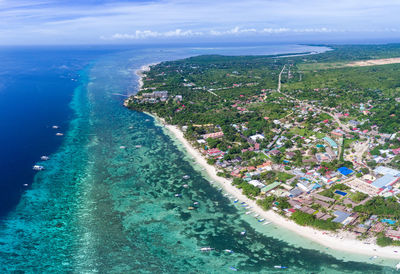 High angle view of sea by trees against sky
