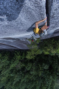 High angle view of person on rock by sea