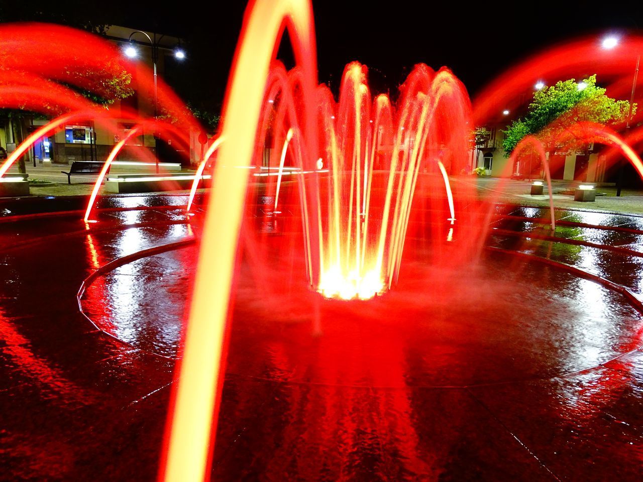 BLURRED MOTION OF ILLUMINATED WATER FOUNTAIN