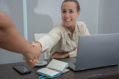 Portrait of woman using laptop on table