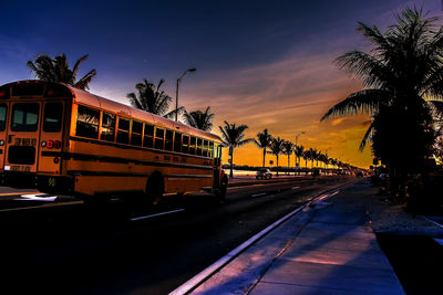 Cars on road at sunset