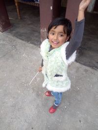 Portrait of smiling girl standing outdoors