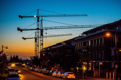 Cars on road in city against clear sky