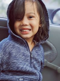 Portrait of smiling girl in car