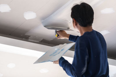 Man plastering on ceiling